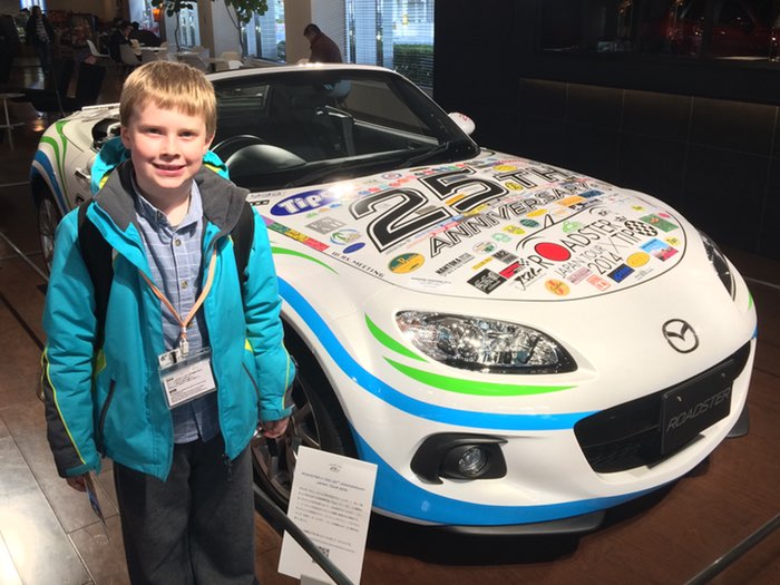 James standing with roadster